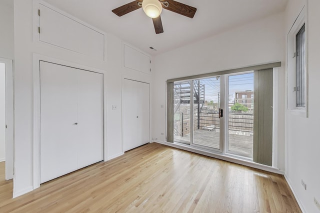 512 N Claremont Ave Unit 2, Chicago, IL 60612 - unfurnished bedroom with access to exterior, light wood-style flooring, and a ceiling fan