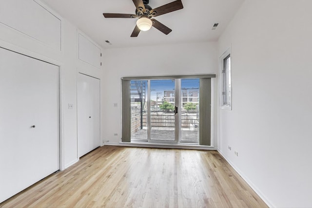 512 N Claremont Ave Unit 2, Chicago, IL 60612 - unfurnished bedroom featuring wood finished floors, access to exterior, ceiling fan, and baseboards