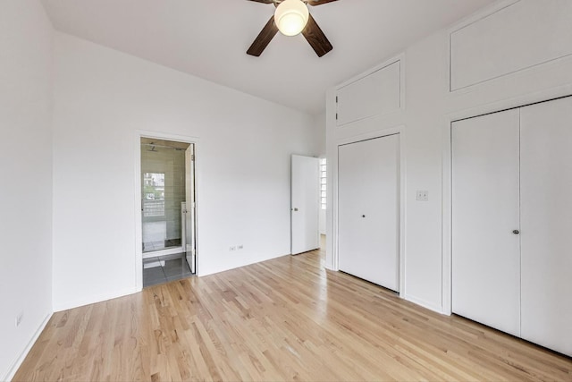 512 N Claremont Ave Unit 2, Chicago, IL 60612 - unfurnished bedroom featuring light wood-style flooring, ensuite bathroom, two closets, and a ceiling fan