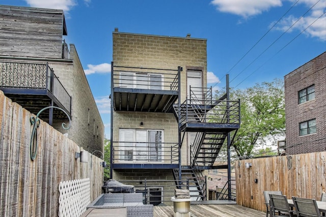 512 N Claremont Ave Unit 2, Chicago, IL 60612 - rear view of property featuring stairs, a balcony, and a wooden deck