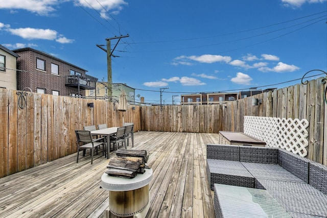 512 N Claremont Ave Unit 2, Chicago, IL 60612 - wooden deck featuring outdoor dining area, a fenced backyard, and an outdoor hangout area