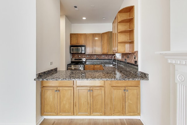 512 N Claremont Ave Unit 2, Chicago, IL 60612 - kitchen with appliances with stainless steel finishes, a sink, open shelves, dark stone countertops, and decorative backsplash