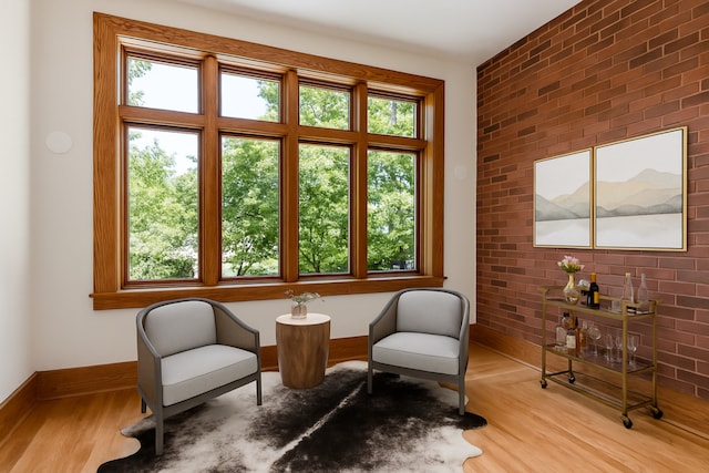 4019 Howard Ave, Western Springs, IL 60558 - living area featuring wood finished floors, brick wall, and baseboards