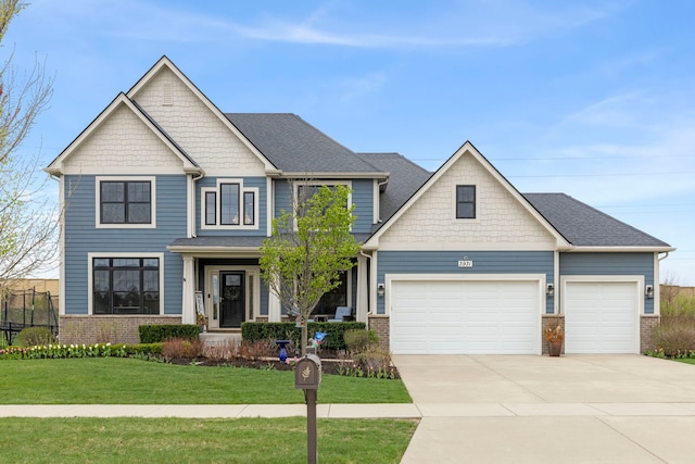 craftsman-style house with brick siding, a front lawn, and concrete driveway