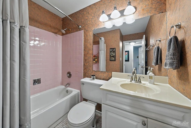 bathroom featuring vanity, toilet, tile patterned floors, and shower / tub combo