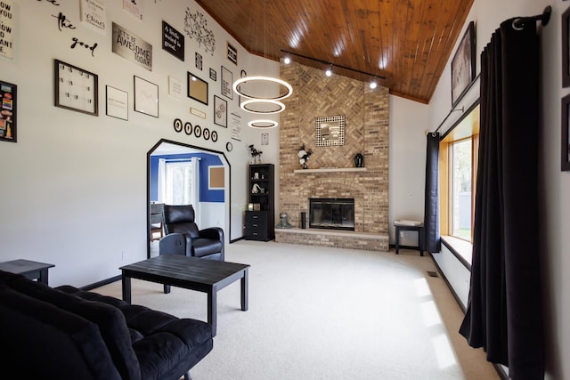 living area with wooden ceiling, light colored carpet, a fireplace, and high vaulted ceiling