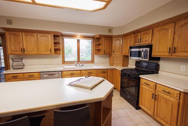 kitchen with open shelves, stainless steel appliances, brown cabinetry, and a sink