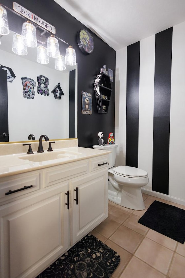 bathroom featuring tile patterned floors, toilet, and vanity
