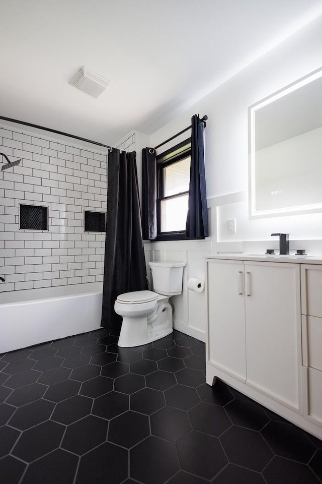 full bathroom featuring shower / tub combo, toilet, visible vents, tile patterned floors, and vanity