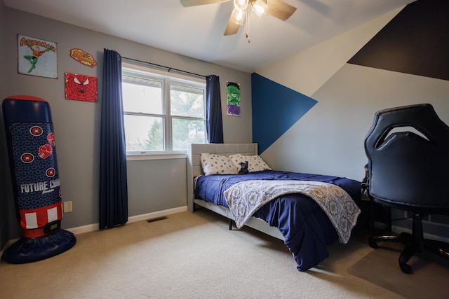 bedroom featuring lofted ceiling, visible vents, ceiling fan, carpet flooring, and baseboards