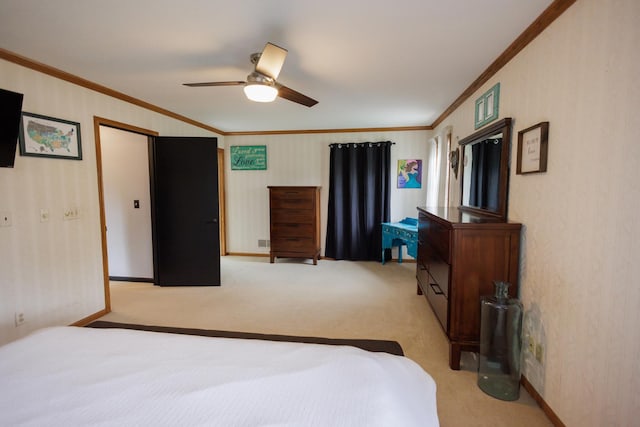 bedroom with light colored carpet, ornamental molding, baseboards, and ceiling fan
