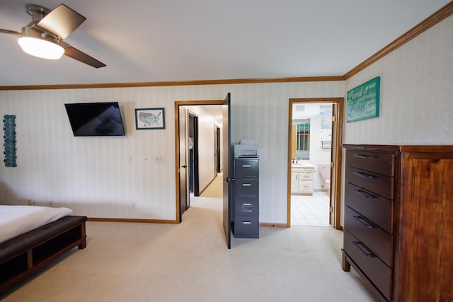 bedroom featuring baseboards, a sink, connected bathroom, crown molding, and light carpet