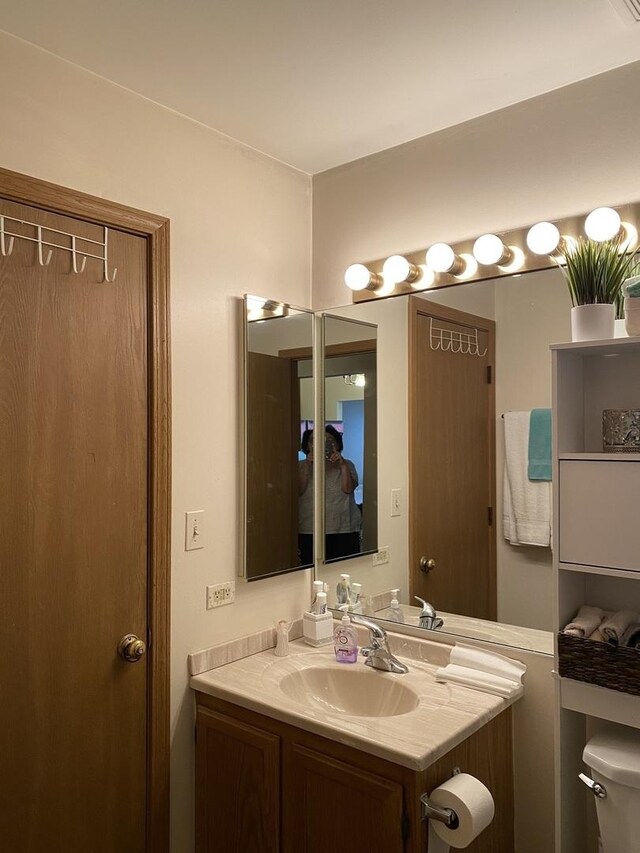 bathroom with toilet and vanity