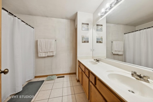 244 Tammanny Ln, Romeoville, IL 60446 - bathroom featuring double vanity, tile patterned flooring, baseboards, and a shower with shower curtain