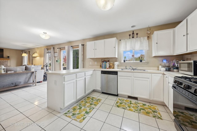244 Tammanny Ln, Romeoville, IL 60446 - kitchen with appliances with stainless steel finishes, a sink, a peninsula, open floor plan, and white cabinetry