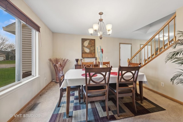 244 Tammanny Ln, Romeoville, IL 60446 - carpeted dining space with baseboards, a chandelier, and stairs