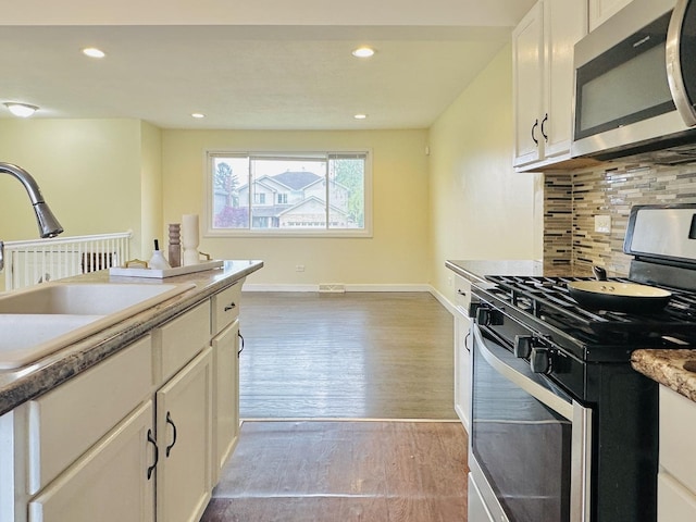 3729 W 121st St, Alsip, IL 60803 - kitchen with a sink, light wood-style flooring, stainless steel appliances, white cabinetry, and backsplash