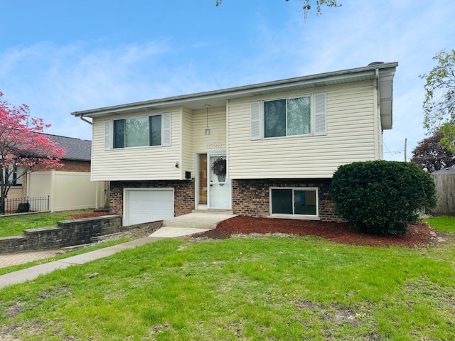 3729 W 121st St, Alsip, IL 60803 - raised ranch featuring brick siding, an attached garage, fence, and a front lawn