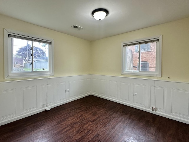 3729 W 121st St, Alsip, IL 60803 - unfurnished room with a healthy amount of sunlight, wainscoting, dark wood-style flooring, and visible vents
