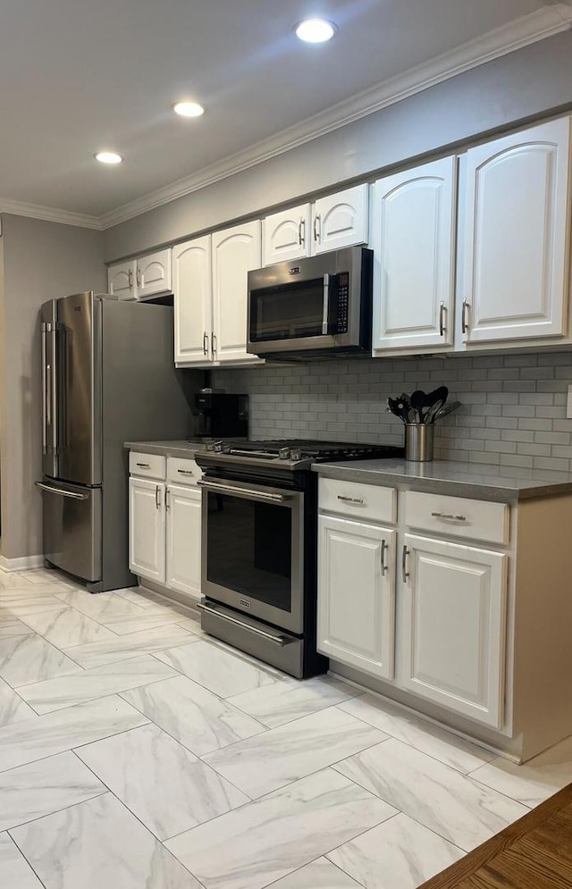 kitchen with crown molding, white cabinets, backsplash, and stainless steel appliances