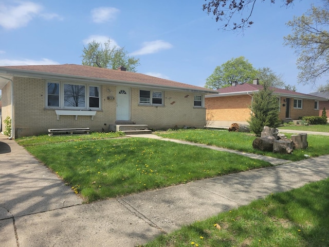 816 N School St, Addison, IL 60101 - view of front facade featuring a front lawn, a chimney, entry steps, and brick siding