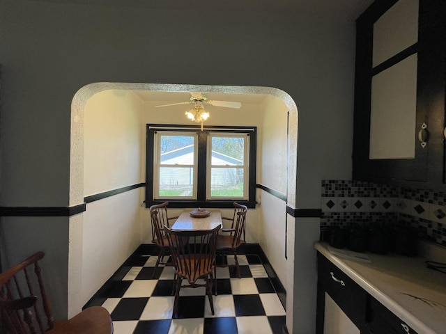 dining area with tile patterned floors and arched walkways