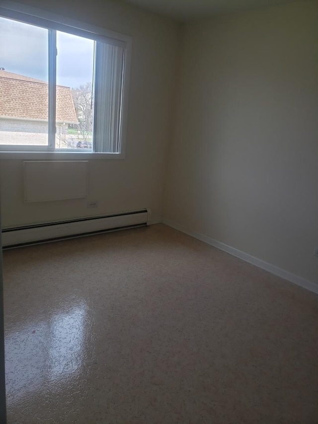277 Shorewood Dr Unit 2A, Glendale Heights, IL 60139 - empty room with a baseboard heating unit and baseboards