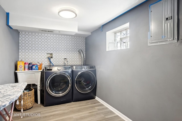 3553 W 77th St, Chicago, IL 60652 - laundry room with laundry area, light wood-type flooring, electric panel, washing machine and dryer, and visible vents