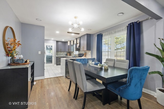 3553 W 77th St, Chicago, IL 60652 - dining space featuring a notable chandelier, baseboards, and light wood-style floors