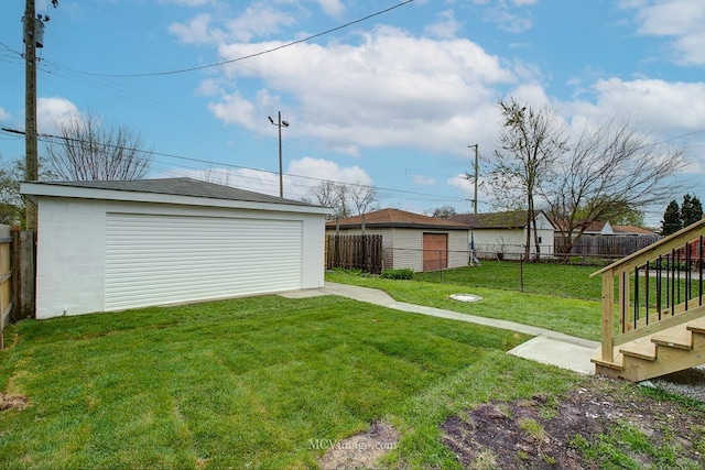 9221 S Lowe Ave, Chicago, IL 60620 - view of yard with a detached garage, a fenced backyard, and an outdoor structure