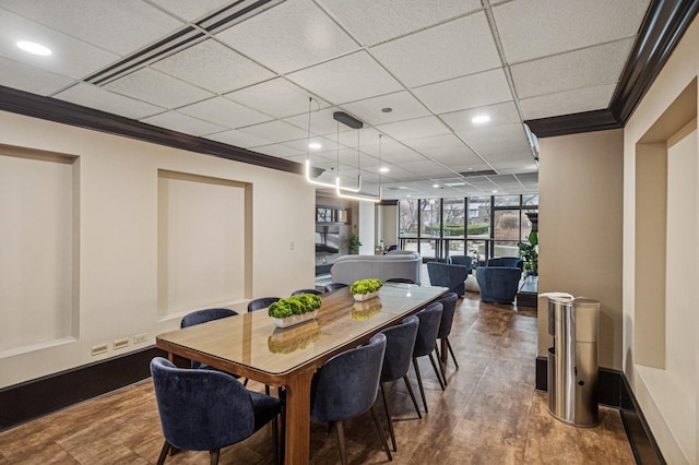 dining space featuring crown molding, recessed lighting, and a drop ceiling