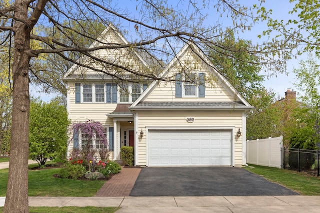 569 Prairie Ave, Glen Ellyn, IL 60137 - traditional-style house featuring driveway, a garage, and roof with shingles