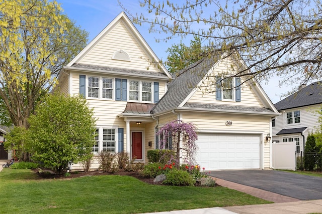 569 Prairie Ave, Glen Ellyn, IL 60137 - traditional home with asphalt driveway, a front yard, a shingled roof, and an attached garage
