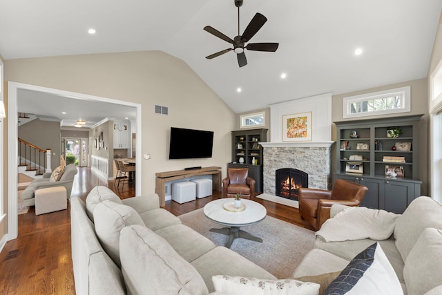 569 Prairie Ave, Glen Ellyn, IL 60137 - living area featuring stairway, a stone fireplace, a ceiling fan, wood finished floors, and high vaulted ceiling