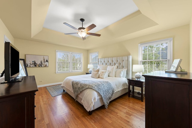 569 Prairie Ave, Glen Ellyn, IL 60137 - bedroom featuring a tray ceiling, light wood finished floors, ceiling fan, and baseboards