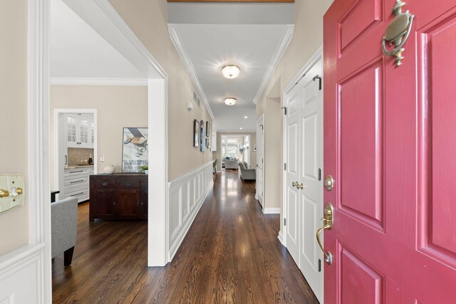 569 Prairie Ave, Glen Ellyn, IL 60137 - foyer with crown molding, dark wood-style floors, and a wainscoted wall