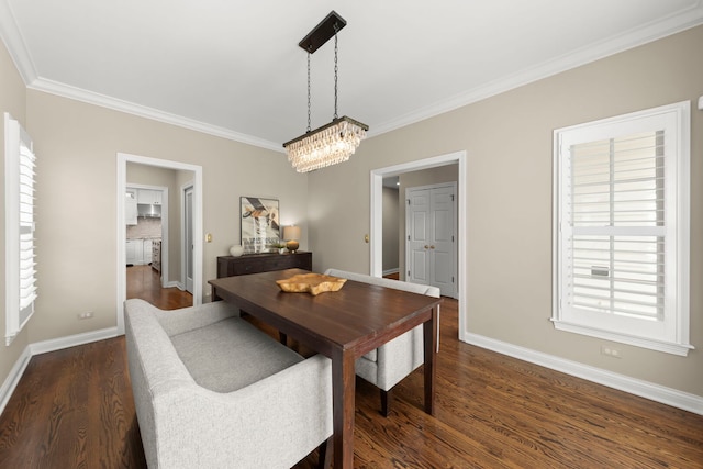 569 Prairie Ave, Glen Ellyn, IL 60137 - dining space featuring crown molding, baseboards, a chandelier, dark wood finished floors, and healthy amount of natural light