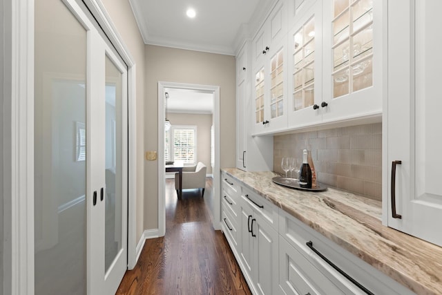 569 Prairie Ave, Glen Ellyn, IL 60137 - indoor dry bar with crown molding, dark wood finished floors, tasteful backsplash, and baseboards