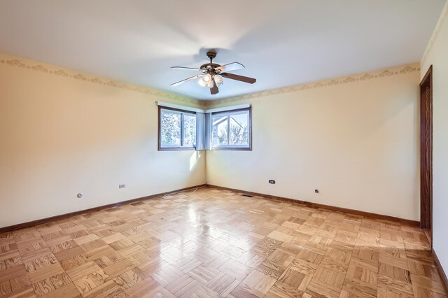 unfurnished room featuring baseboards and a ceiling fan