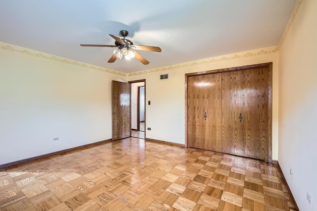 unfurnished bedroom featuring baseboards, visible vents, and ceiling fan