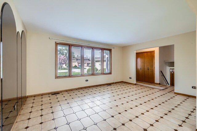 spare room featuring baseboards