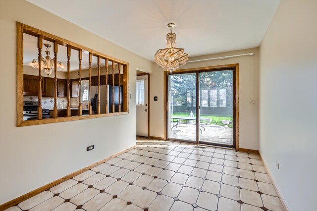 interior space with an inviting chandelier and baseboards