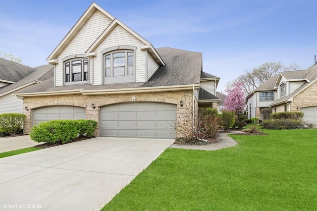 view of front of property with brick siding, a shingled roof, a front yard, concrete driveway, and an attached garage