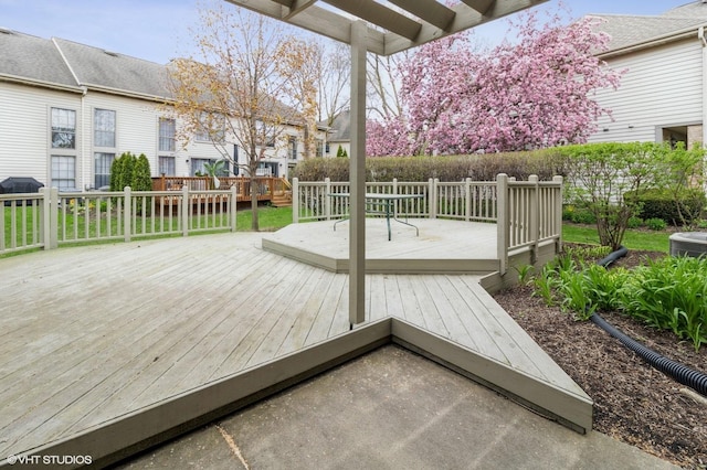 wooden deck with grilling area, cooling unit, and a residential view