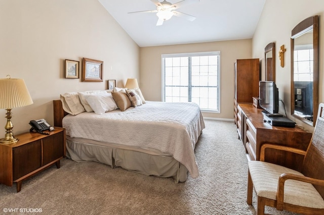 carpeted bedroom featuring lofted ceiling, a ceiling fan, and baseboards