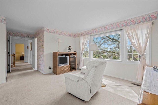 carpeted living area with baseboards, wallpapered walls, and visible vents