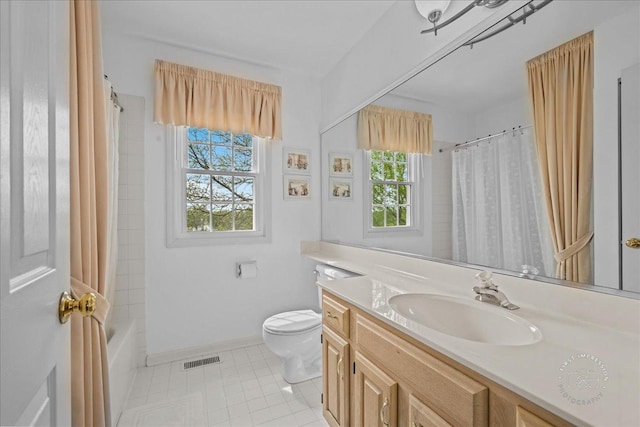 bathroom with vanity, visible vents, toilet, baseboards, and tile patterned floors