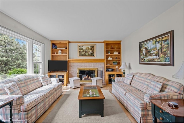 living area featuring light wood-style floors and a fireplace