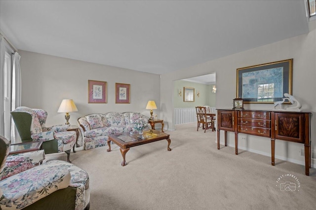 carpeted living room with a healthy amount of sunlight and baseboards