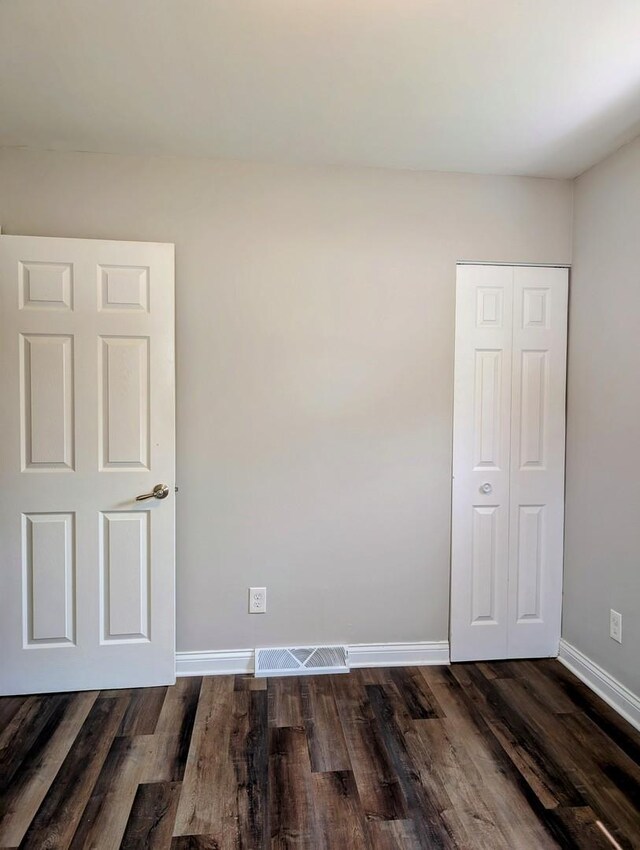 1514 173rd St, East Hazel Crest, IL 60429 - spare room featuring baseboards and dark wood-style flooring